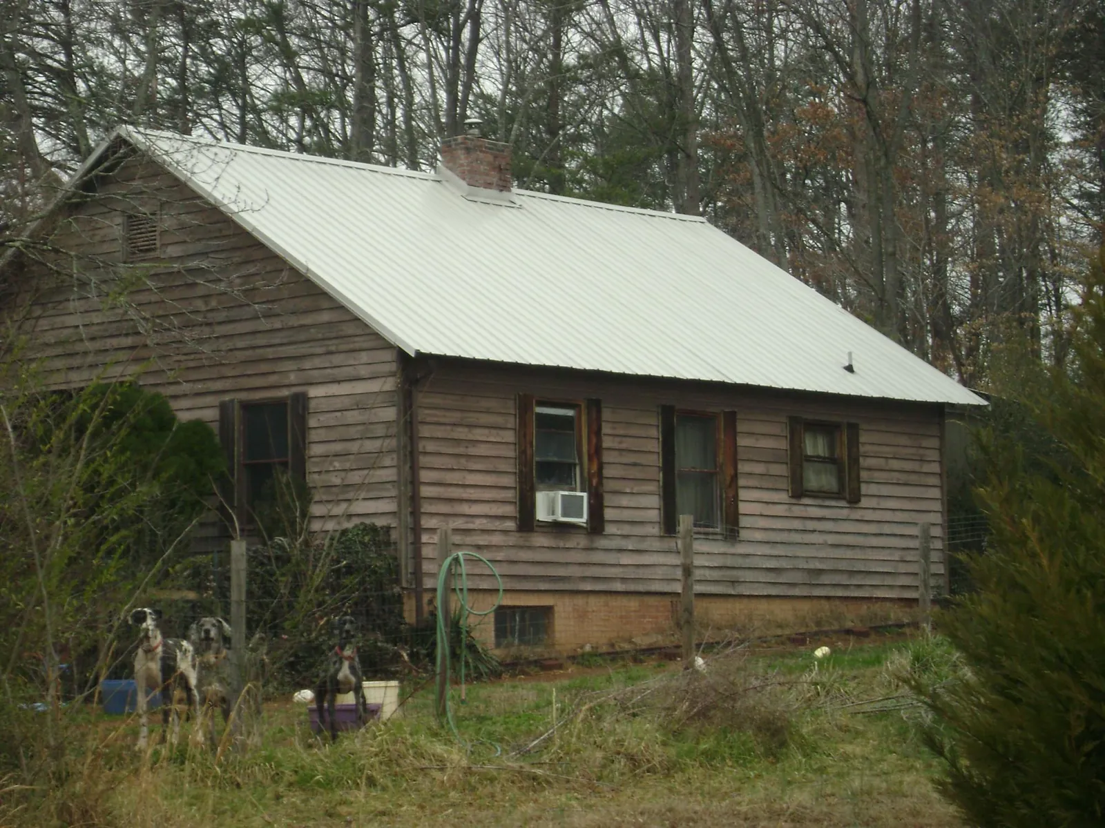 White metal roof on an old wood sided farmhouse, from a Metal Roof Installation job in Waldo